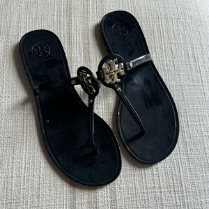 Tory Burch black flip flops with gold emblem.  7.5